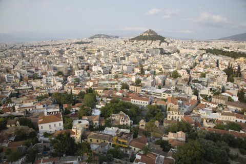 Athens, Attica, Greece. Mount Lycabettus rising in central Athens with densely populated city below