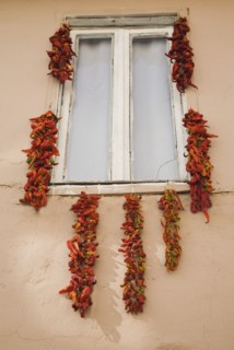 Kusadasi, Aydin Province, Turkey. Strings of red and orange chili peppers hung up to dry in summer