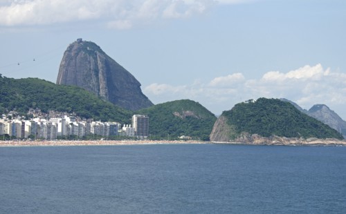 Rio de Janeiro, Brazil. Copacabana beach. Hotels and crowds on the beach in the distance blue sea
