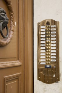 Vienna, Austria. Polished brass bell and names of residents at apartment entrance. Austria Austrian