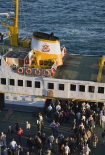 Istanbul, Turkey. Sultanahmet Bosphorous passenger ferry at sunset with people gathered to board.