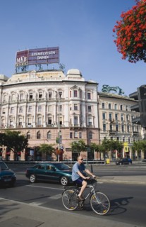 Budapest, Pest County, Hungary. Cyclist and traffic at the rail terminus Budapest Nyugati