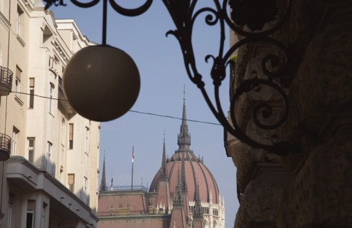 Budapest, Pest County, Hungary. Art Nouveau era apartment facades with domed roof of Hungarian
