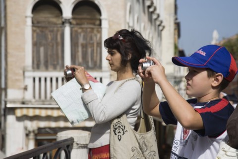 Venice, Veneto, Italy. Mother and son take photographs of canal view opposite St. Marks. Italy