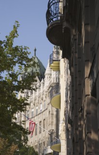 Budapest, Pest County, Hungary. Renovated apartment buildings with US embassy and flag behind.
