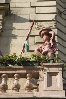 Budapest, Pest County, Hungary. Art Nouveau exterior facade with rolled Hungarian flag flower pots