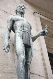 Budapest, Pest County, Hungary. Art Nouveau bronze standing figure at apartment entrance. Hungary