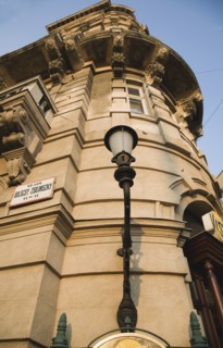 Budapest, Pest County, Hungary. Part view of renovated apartment exterior facade with street sign