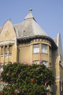 Budapest, Pest County, Hungary. Part view of Empire era apartment blocks with baskets of pink