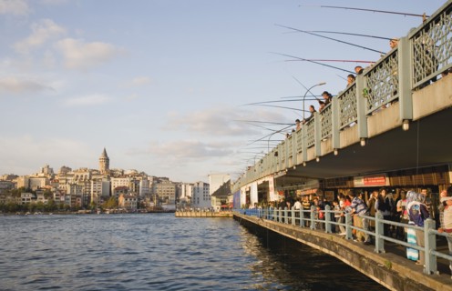 Istanbul, Turkey. Sultanahmet. View towards Galata Tower with men fishing from Galata bridge above