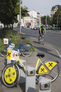Vienna, Austria. Neubau District. Bicycles for use in city centre with approaching cyclist on road