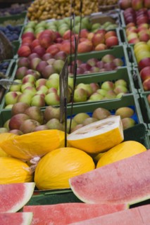 Vienna, Austria. The Naschmarkt. Market fruit stall with display of melon and apples. Austria