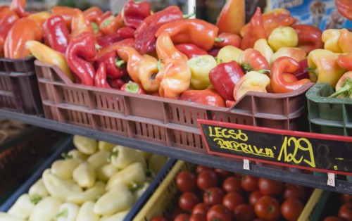 Budapest, Pest County, Hungary. Crate of red orange and yellow Capsicum annuum or Bell Chili