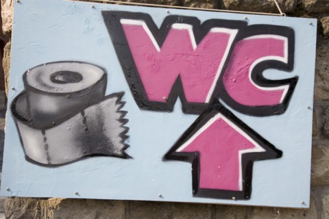 Budapest, Pest County, Hungary. Painted sign for toilet. Hungary Hungarian Europe European East