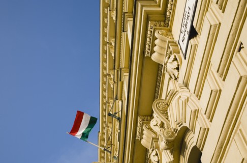 Budapest, Pest County, Hungary. Renovated facade on Pest bank of Danube with Hungarian flag.