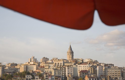 Istanbul, Turkey. Sultanahmet. View to Galata Tower from shade of red canopy alongside Galata