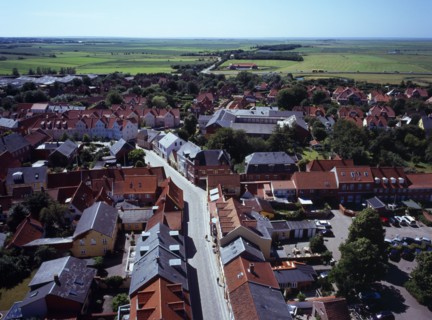 Denmark, Jutland, Ribe, View south-west over city rooftops and cobbled street towards farmland from