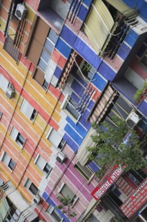 Albania, Tirane, Tirana, Angled part view of apartment block painted in brightly coloured stripes