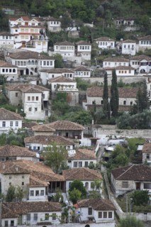 Albania, Berat, Traditional white painted Ottoman buildings with tiled rooftops on hillside in the