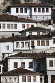 Albania, Berat, Ottoman houses in the old town with white painted exteriors and tiled roof tops.