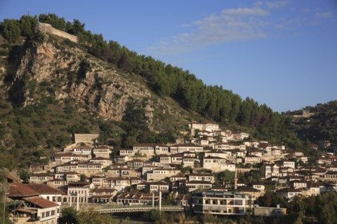 Albania, Berat, Traditional Ottoman buildings on hillside above footbridge over the River Osum.