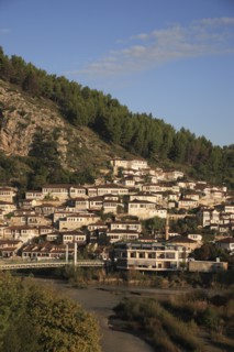 Albania, Berat, Traditional Ottoman buildings on hillside above footbridge over the River Osum.