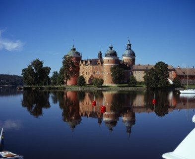 Sweden, Sodermanland, Mariefred, Gripsholm Castle beside Lake Malaren.  Red brick exterior with