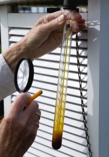 Climate, Weather, Measurements, Weather observer using a magnifying glass to read the a thermometer