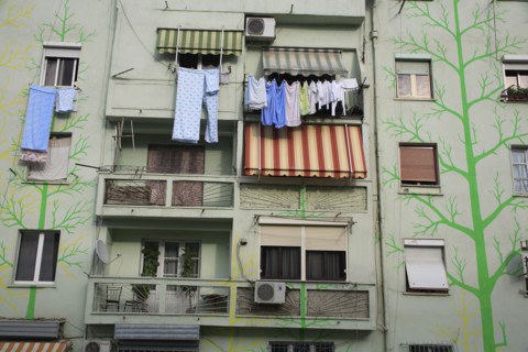 Albania, Tirane, Tirana, Detail of exterior facade of apartment block painted with tree forms in