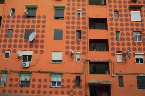 Albania, Tirane, Tirana, Part view of exterior facade of apartment block painted orange with