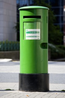 Ireland, County Dublin, Dublin City, A traditional old fashioned green letterbox on the pavement