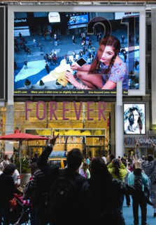 USA, New York, New York City, Manhattan  People waving and looking at themselves in a giant live