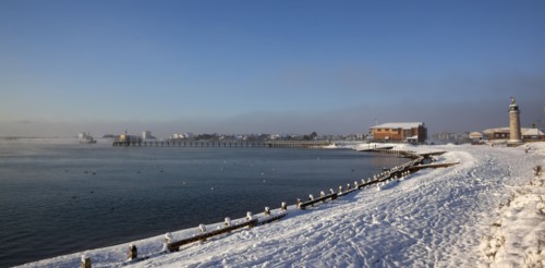 England, West Sussex, Shoreham-by-Sea , Mist rising from harbour waters on frosty morning with snow