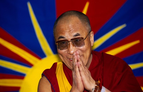 China, Tibet, Religious, The Dalai Lama smiling with hands raised in a traditional anjali greeting