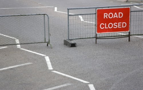 Transport, Road, Signs, Red Road Closed Traffic sign on barrier across empty urban road.