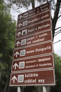 Albania, Kruja, Bi-lingual road sign giving direction to places of interest in Kruja.