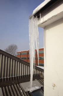 Weather, Winter, Ice, Large Icicle hanging from roof gutters.