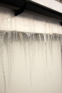 Weather, Winter, Ice, Large Icicles hanging from roof eaves.