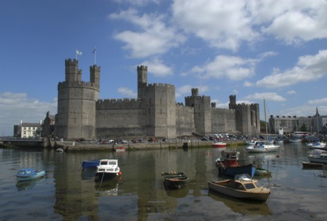 Wales, Gwynedd, Conway, Conway Castle seen over moored boats in the harbour