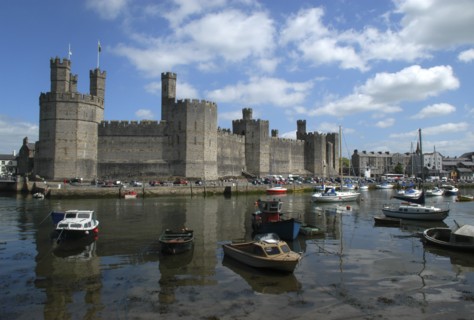 Wales, Gwynedd, Conway, Conway Castle seen over moored boats in the harbour