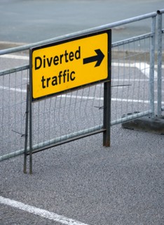 Transport, Road, Signs, Yellow Diverted Traffic diversion sign on barrier across empty urban road