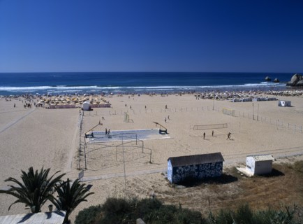 Portugal, Algarve, Praia da Rocha, View along beach with basketball & volleyball play areas
