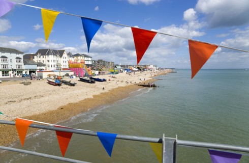 England, West Sussex, Bognor Regis, The pebble shingle beach and seafront with tourists seen