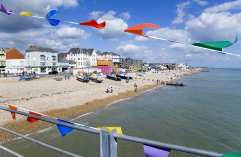 England, West Sussex, Bognor Regis, The pebble shingle beach and seafront with tourists seen