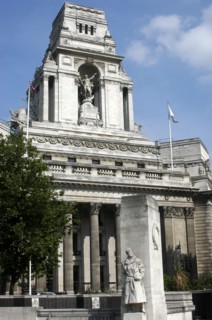 England, London, Memorial statue of a soldier with architecture behind