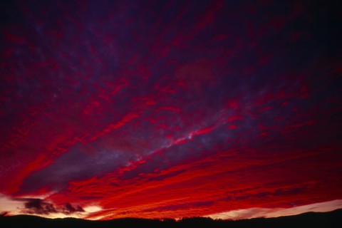 England, Climate, Sunset, Narrow  strip of land silhouetted against dramatic sunset sky with clouds