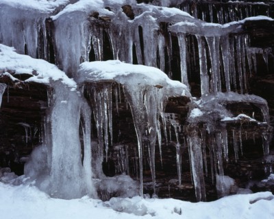Climate, Winter, Ice, Long icicles hanging from rock face.