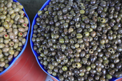 Albania, Tirane, Tirana, Bowls of olives displayed for sale in the Avni Rustemi Market.
