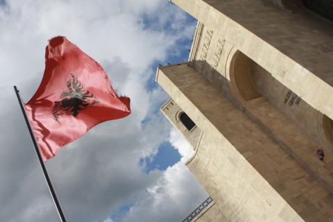 Albania, Kruja, National flag depicting black double headed eagle against red background flying at