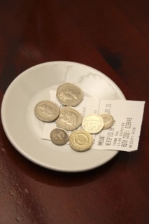 Food And Drink, Restaurant, Service, Saucer with credit card payment receipt and tip left for